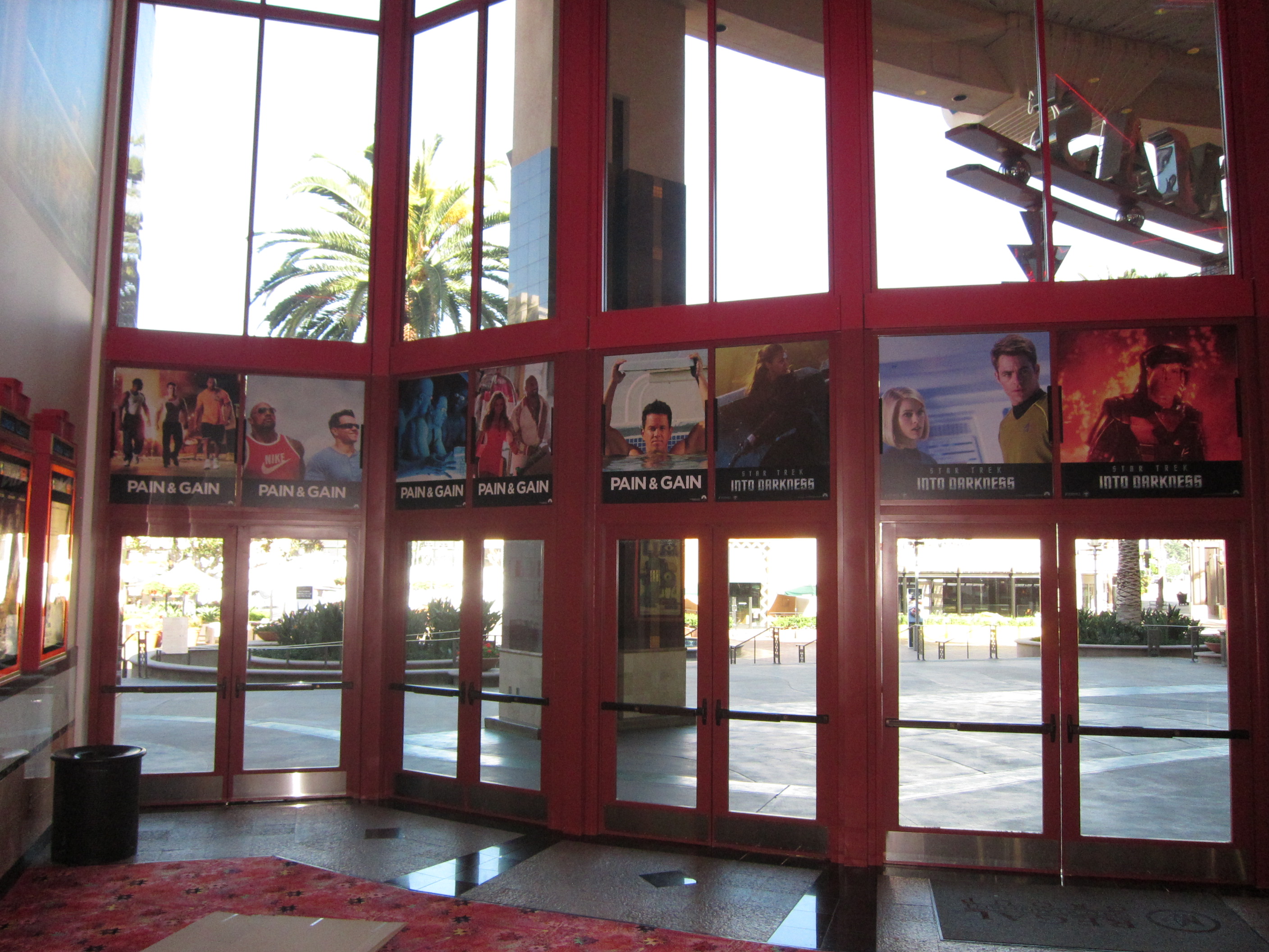 PAIN AND GAIN double sided color photo boards above the doors viewed from inside the theatre lobby.