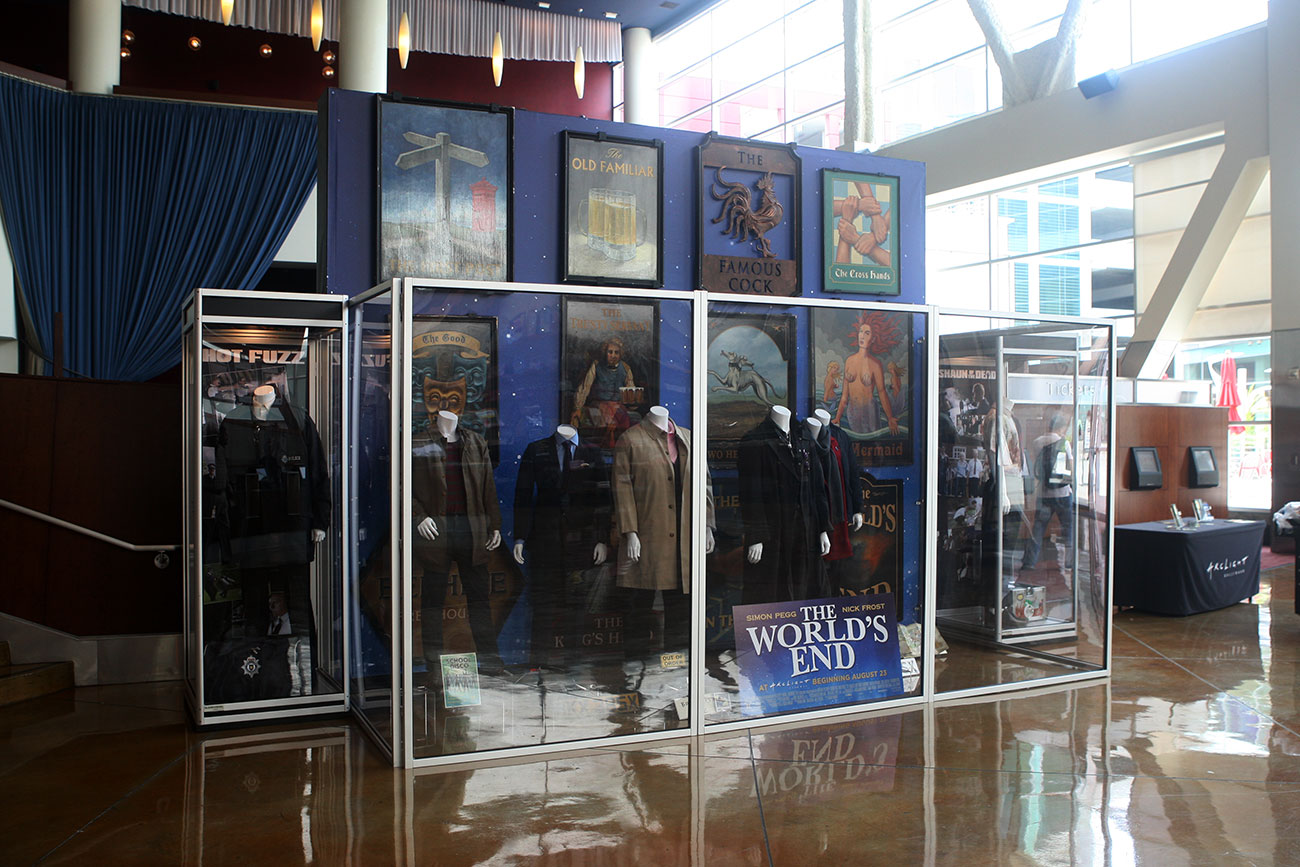 The single case on the left features the original costume and props for Simon Pegg from HOT FUZZ.